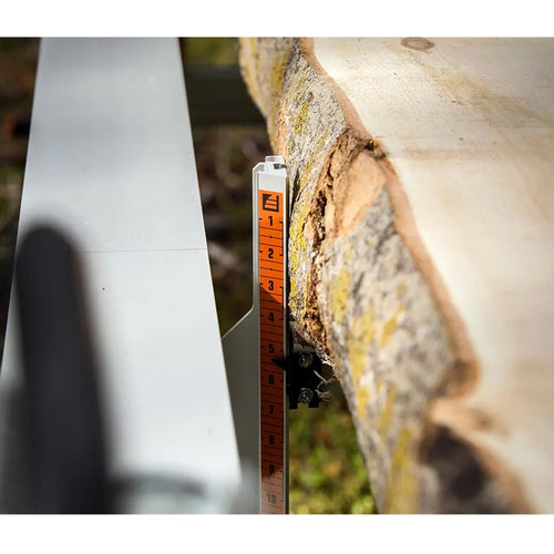 Close-up of a measurement scale on a portable metal lumber sawmill cutting a large log, highlighting precision craftsmanship for Farm, Garden & Tool, Wood Cutting and Hauling, and Best Sellers collections.