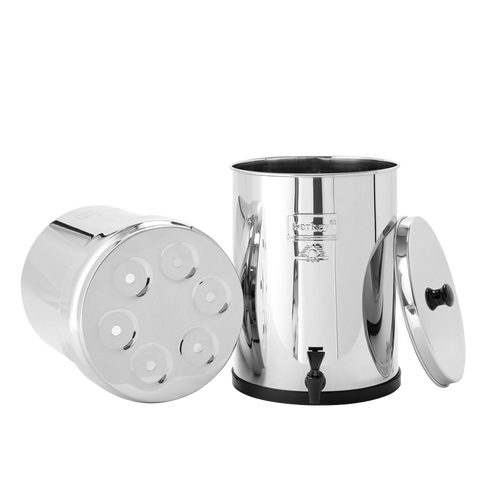 Highly polished stainless steel water filtration system with removable lid and bottom chamber featuring multiple filter element ports, part of appliances and emergency supplies collections.