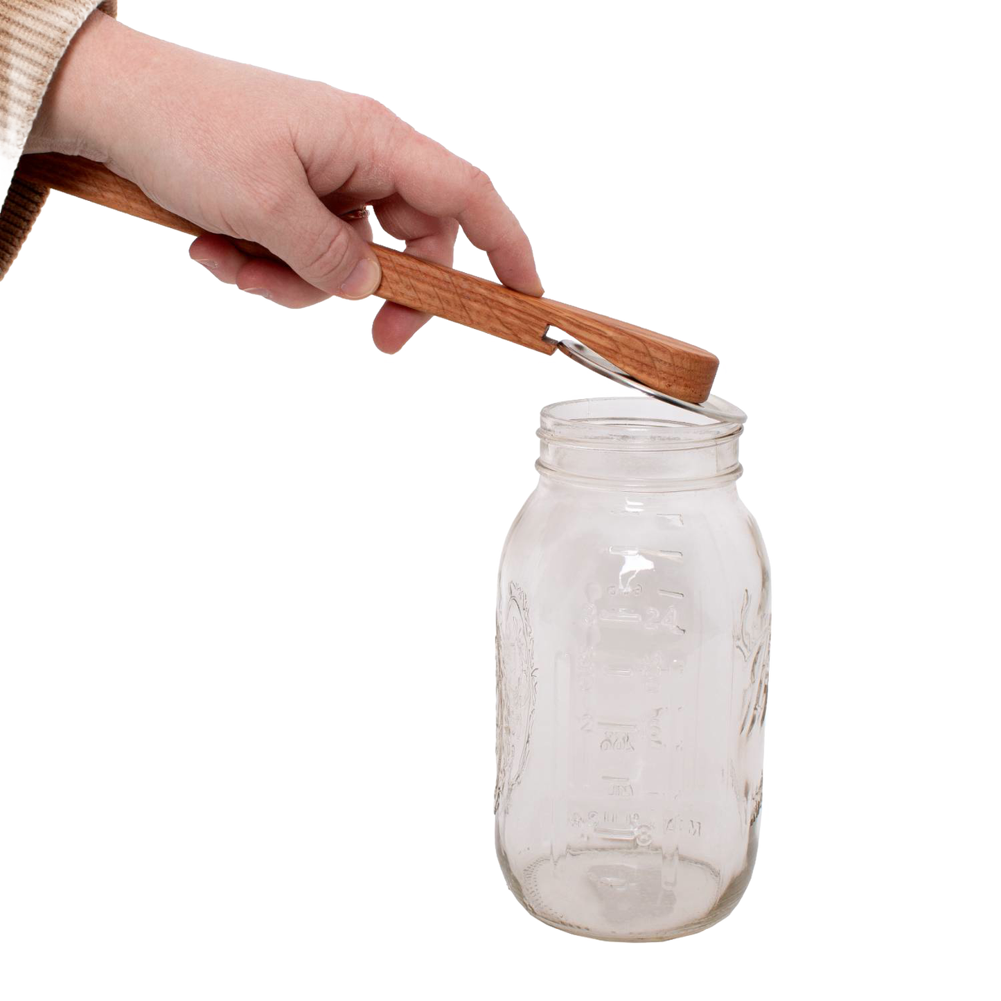 Handcrafted oak jar opener held above a clear glass Mason jar, designed by Amish artisans for easy removal of canning lids, featured in Kitchen & Food and Canning Accessories collections.