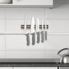 Heavy duty hardwood magnetic knife holder mounted on tiled kitchen wall, securing five knives with gray handles, perfect for organizing in Farm, Garden & Tool, Kitchen & Food, and Knives & Axes collections.