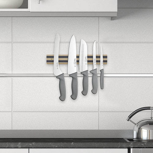Heavy duty hardwood magnetic knife holder mounted on tiled kitchen wall, securing five knives with gray handles, perfect for organizing in Farm, Garden & Tool, Kitchen & Food, and Knives & Axes collections.