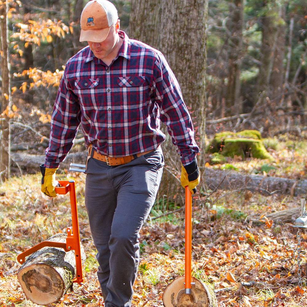 Man outdoors using bright orange LogOX Forester multitool and PickOX Pickaroon attachment to lift and carry logs with reduced strain, featured for Farm, Garden & Tool, Wood Cutting and Hauling, USA Made, Best Sellers, and Promo Eligible collections.