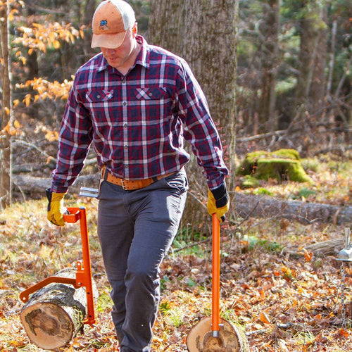 Man outdoors using bright orange LogOX Forester multitool and PickOX Pickaroon attachment to lift and carry logs with reduced strain, featured for Farm, Garden & Tool, Wood Cutting and Hauling, USA Made, Best Sellers, and Promo Eligible collections.