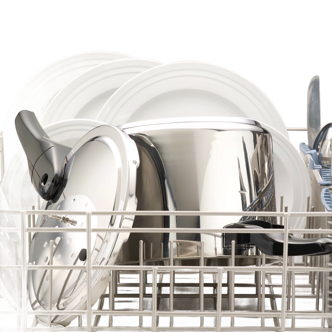 Polished stainless steel pressure cooker with lid inside a dishwasher rack alongside white plates, featured for Kitchen & Food, Cookware, Pots and Pans, Best Sellers, and Promo Eligible collections.