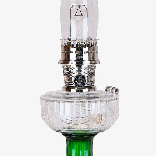 Clear glass oil lamp with emerald green glass base and metal burner featuring a handcrafted sweeping drape pattern, perfect for Lamps & Lighting, Oil Lamps, and Best Sellers collections.