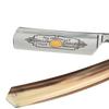 Close-up of a handcrafted straight razor featuring a polished hollow ground blade with intricate engraving and a smooth, natural-toned handle, suitable for Grooming and Personal Hygiene, Health & Wellness, Best Sellers, and Promo Eligible collections.