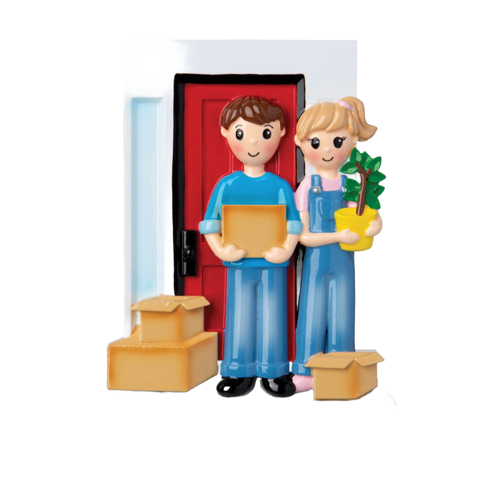 Handcrafted resin ornament of a smiling couple in casual clothes standing in front of a red door with moving boxes and a small green plant, part of Home & Decor and Holiday Decor collections.