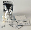 Home water testing kit with clear vials, test strips for detecting pesticides and lead, and sealed foil pouches for easy, DIY water quality testing in appliances and water treatment.