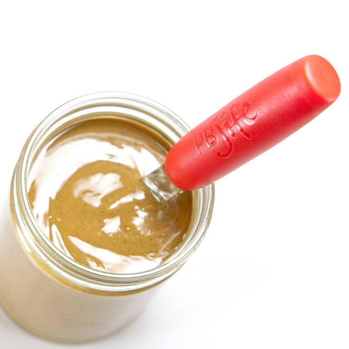 Handcrafted peanut butter spreader with ergonomic red handle and broad blade reaching deep into jar, designed for easy stirring and spreading, ideal for Kitchen & Food and Kitchen Gadgets collections.