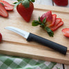 Curved hand-sharpened stainless steel paring knife with a black handle resting on a wooden cutting board beside sliced and whole fresh strawberries, handcrafted and made in USA, featured in Farm, Garden & Tool and Kitchen & Food collections.