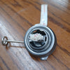 Close-up of a metal burner with attached wick for oil lanterns, designed as a replacement part for vintage camping and emergency lighting in lamps and outdoor collections.