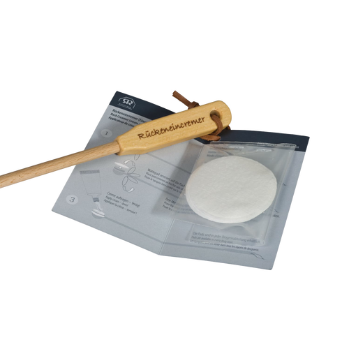 Back creamer and lotion applicator with a wooden curved handle and replaceable soft pads, designed for easy reach and application in Health & Wellness and Grooming collections.