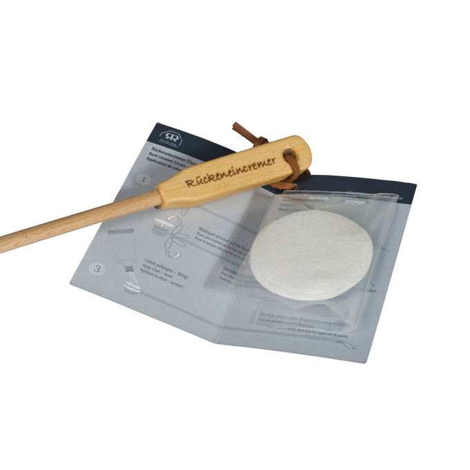 Back creamer and lotion applicator with a wooden curved handle and replaceable soft pads, designed for easy reach and application in Health & Wellness and Grooming collections.