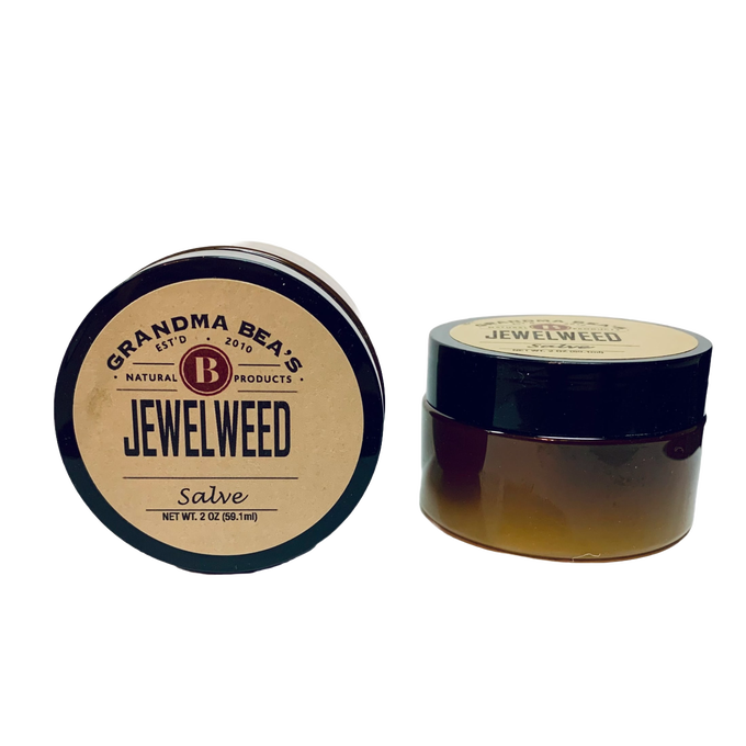 Two small amber glass jars with black lids containing handcrafted jewelweed salve, a natural remedy for itch relief, featured in Health & Wellness and USA Made collections.