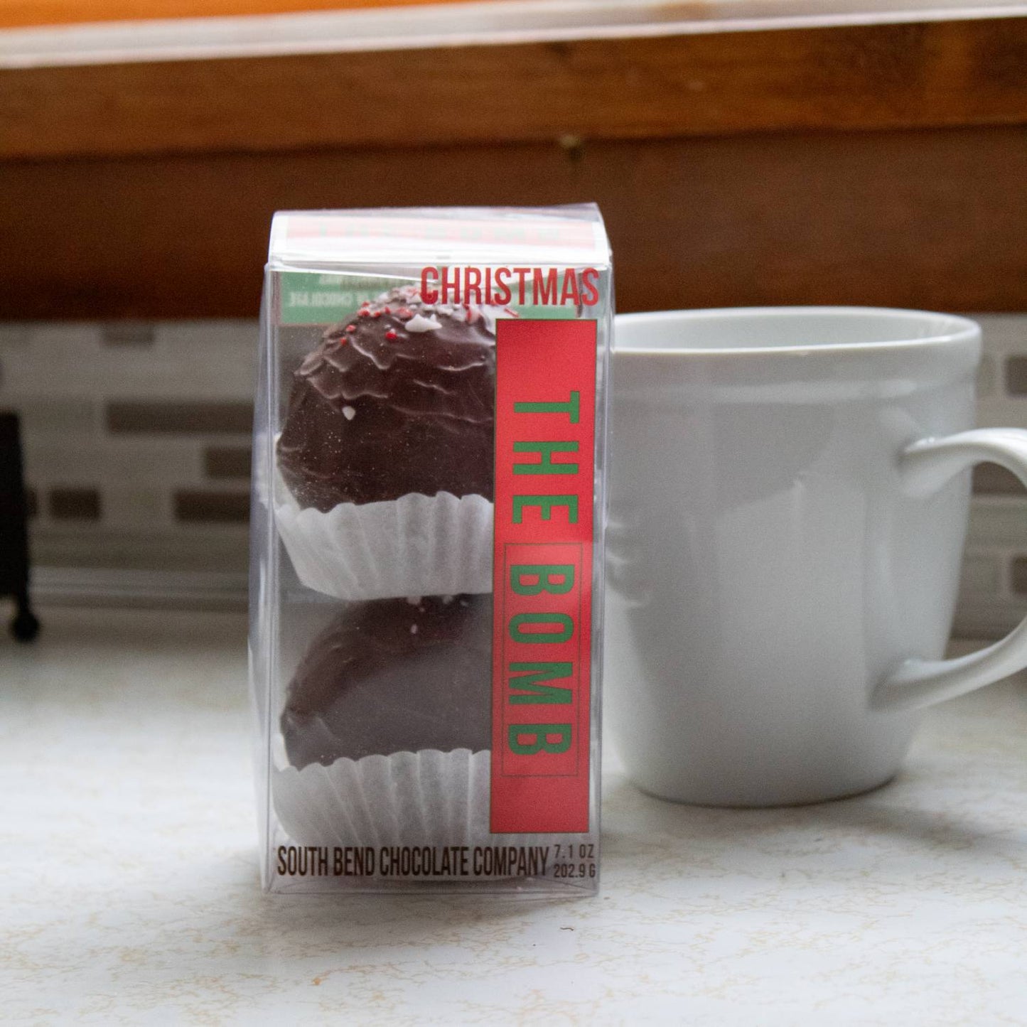Clear packaging showcasing two handcrafted chocolate spheres topped with crushed peppermint candy in white paper cups, made in USA, ideal for Kitchen & Food, Snacks and Sweets, Beverages, USA Made, Best Sellers, and Promo Eligible collections.