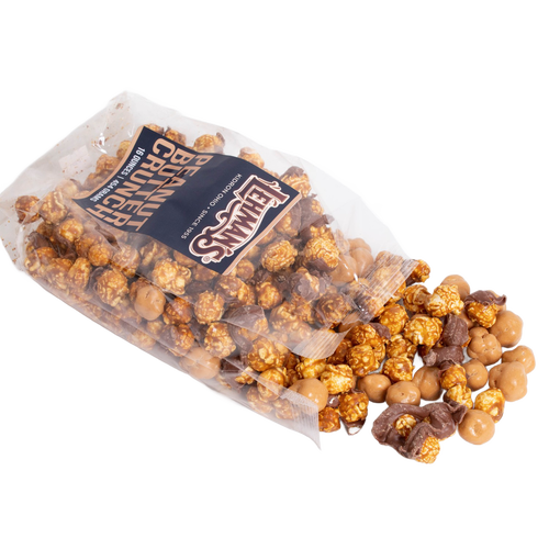 Clear bag of handcrafted caramel popcorn crunch mixed with chocolate-coated peanut butter clusters, a unique sweet and crunchy snack made in USA, ideal for Kitchen & Food, Snacks and Sweets, Popcorn, USA Made, and Best Sellers collections.