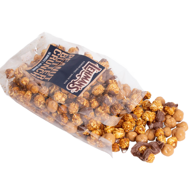 Clear bag of handcrafted caramel popcorn crunch mixed with chocolate-coated peanut butter clusters, a unique sweet and crunchy snack made in USA, ideal for Kitchen & Food, Snacks and Sweets, Popcorn, USA Made, and Best Sellers collections.