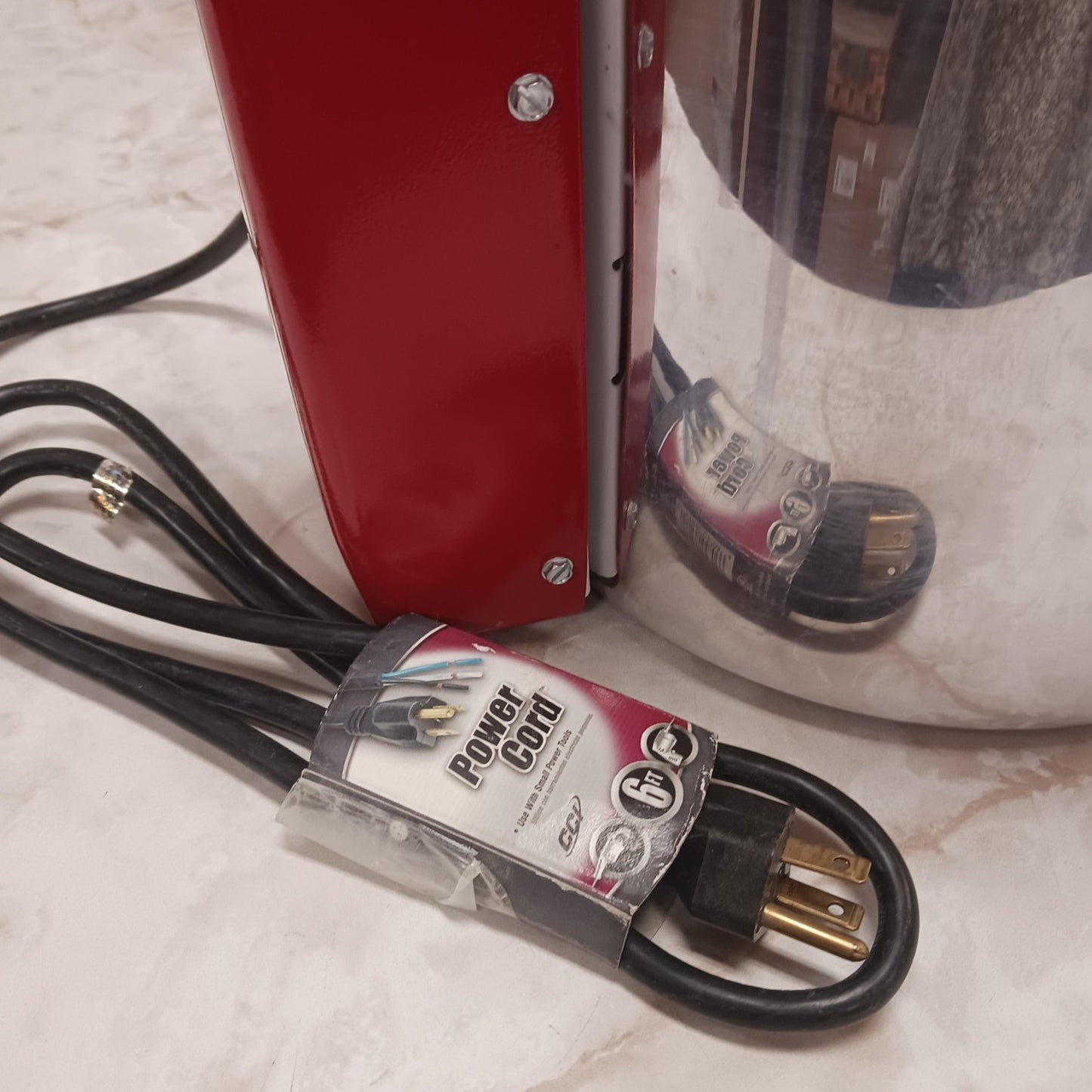Close-up of a heavy-duty power cord with three-prong plug next to a stainless steel and red electric appliance, featured in Farm, Garden & Tool, Animal Care, Best Sellers, and Promo Eligible collections.