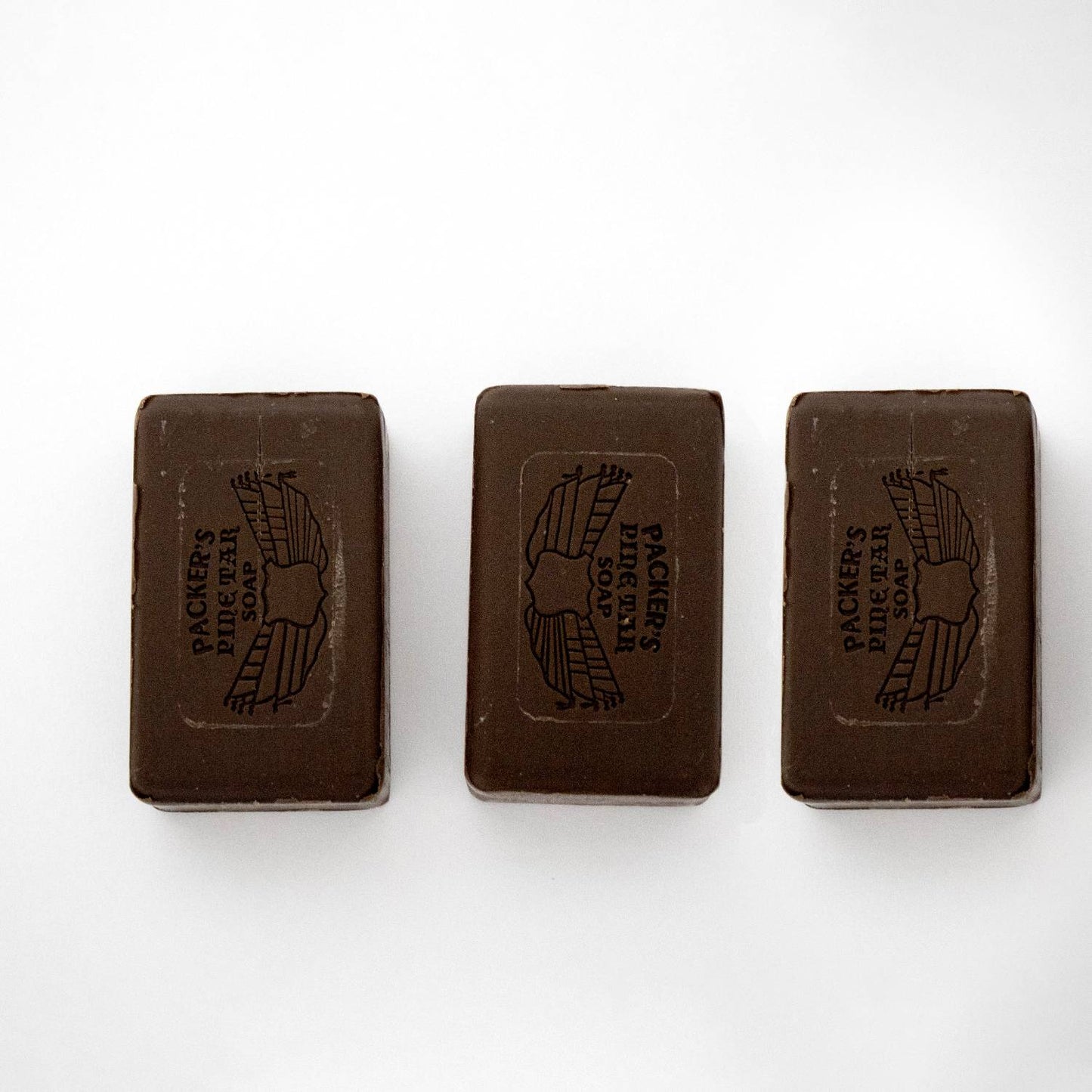 Three handcrafted brown pine tar soap bars, made in the USA, arranged side by side on a plain white background, featured in Health & Wellness and Grooming collections.