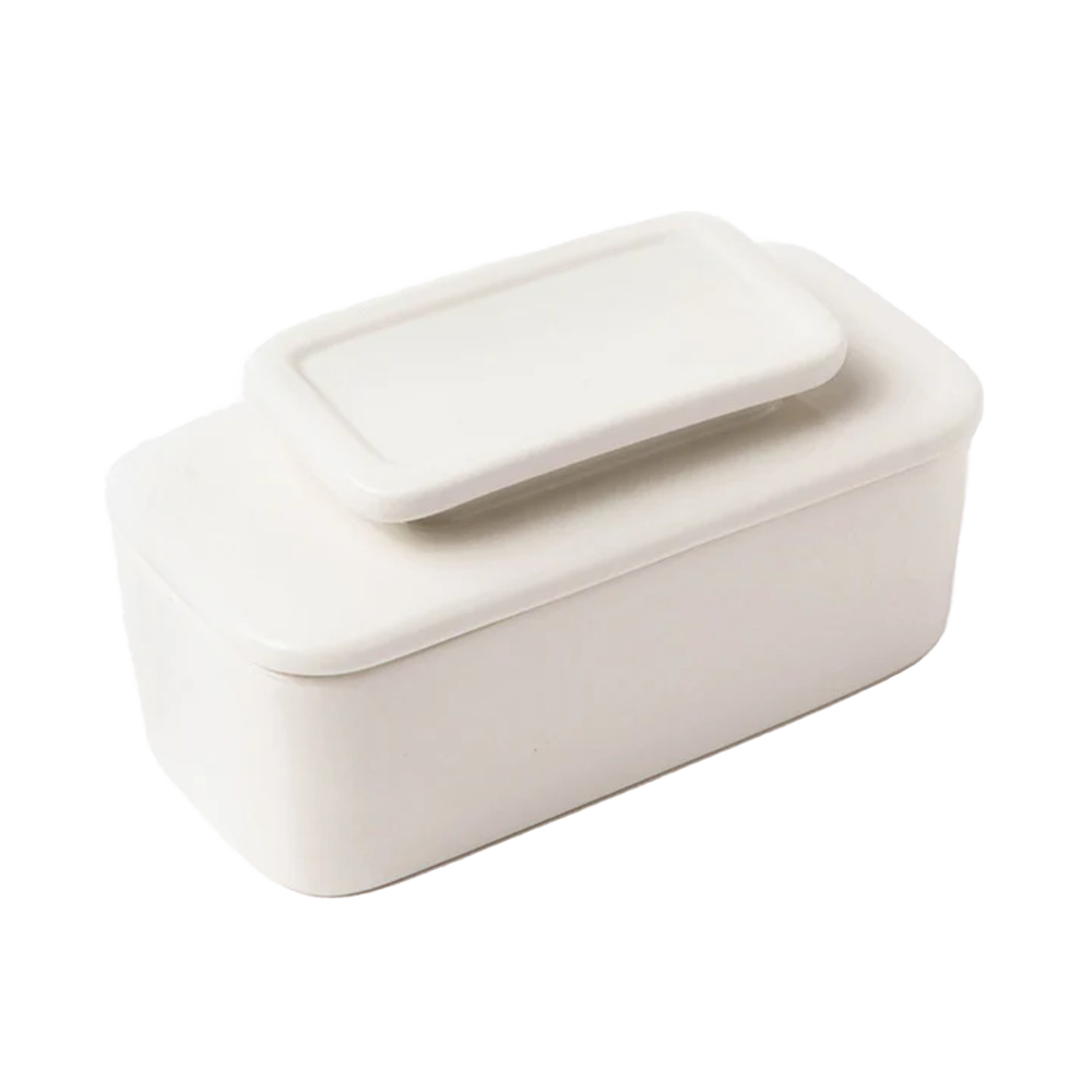 Simple white ceramic butter keeper with rectangular shape and fitted lid, designed for storing full sticks of butter using an airtight water seal, part of Kitchen & Food collections.