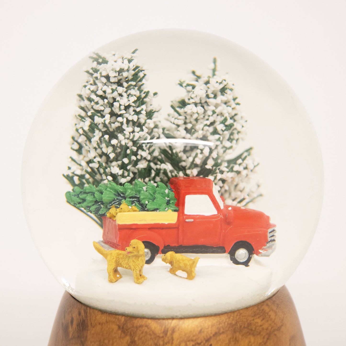 Handcrafted snow globe featuring a red truck with a Christmas tree and two dogs in snow, perfect for Home & Decor, Holiday Decor, and Best Sellers collections.