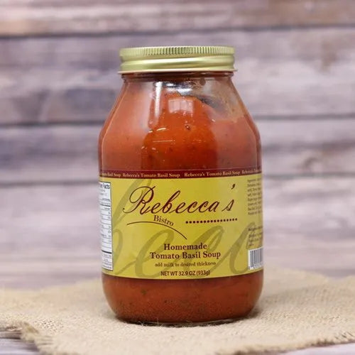 Handcrafted jar of tomato basil soup with a gold lid and yellow label on burlap, highlighting a savory Amish-made favorite in Kitchen & Food, Soups, USA Made, and Best Sellers collections.