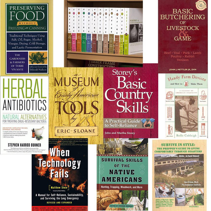 Collection of survival and self-reliance books on a shelf and table, including Amish-made titles on food preservation, butchering, herbal remedies, and traditional skills for emergency preparedness.