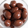 Glossy milk chocolate-coated almonds in a clear dish, handcrafted with roasted cinnamon flavor, featured in Kitchen & Food, Snacks and Sweets, USA Made, Best Sellers, and Promo Eligible collections.
