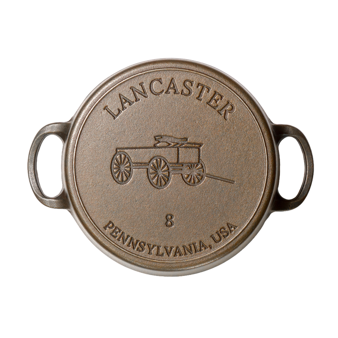 Top view of a handcrafted, Amish-made cast iron Dutch oven lid featuring a vintage wagon design and size 8 marking, made in USA, ideal for Kitchen & Food and Cast Iron collections.