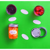 Set of dissolvable oval labels with decorative borders displayed alongside jars of homemade preserves and canning lids on a bright green background, suited for Kitchen & Food, Food Preservation, Canning Accessories, USA Made, and Best Sellers collections.