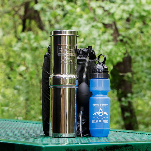 Compact stainless steel water filtration kit with portable components including a blue reusable bottle, designed for camping, emergency supplies, and outdoor use in USA Made collections.
