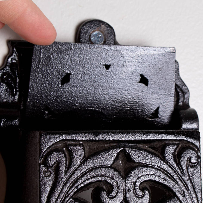 Handcrafted black cast iron wall-mounted matchbox holder with vintage ornamental design, made in USA, perfect for Home & Decor, Household Helpers, Lamps & Lighting, and Best Sellers collections.