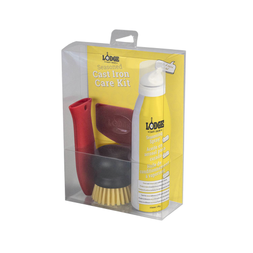 Clear packaging containing a cast iron care kit with a yellow seasoning spray bottle, a red silicone handle holder, a nylon scrub brush, and a pan scraper, featured in Kitchen & Food and Cast Iron collections.