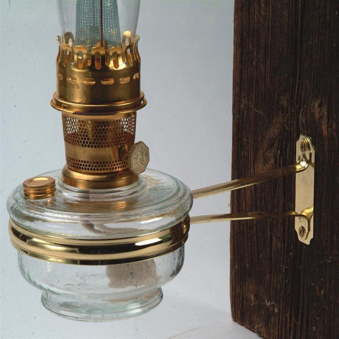 Polished brass classic wall bracket with 11-3/4" arm and 6" diameter ring mounted on wood, handcrafted to hold Aladdin-style oil lamps, ideal for Lamps & Lighting and Oil Lamps collections.