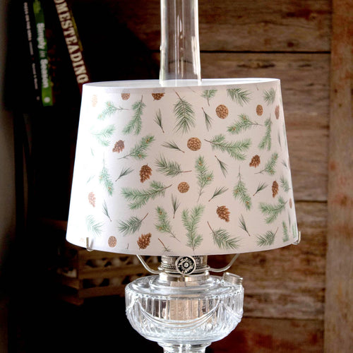 Handcrafted parchment lamp shade featuring delicate pine bough and pinecone patterns, softening light for a cozy ambiance; ideal for Lamps & Lighting, Parts and Accessories, and Lamp Shades collections.