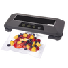 Sleek automatic electric vacuum sealer securing a clear bag filled with fresh mixed fruit, featured in Kitchen & Food, Food Preservation, Freezing, Best Sellers, and Promo Eligible collections.