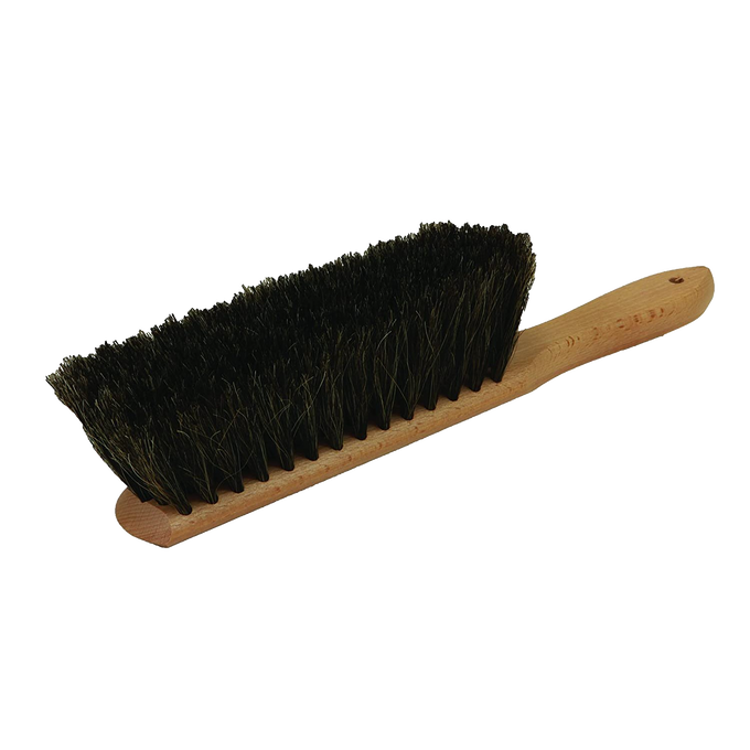 Hand brush with dense natural horsehair bristles and a smooth wooden handle featuring a hanging hole, designed for efficient sawdust removal in farm, garden, and tool care.