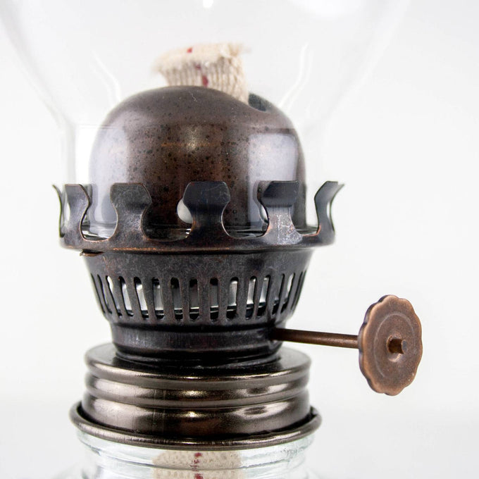 Close-up of a handcrafted vintage-style oil lamp burner with visible flat wick, featuring rustic metal details and adjustable flame control, ideal for traditional lighting and emergency supplies.