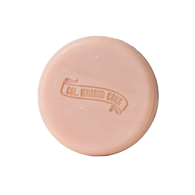 Round almond-scented shaving soap bar with embossed logo, crafted with moisturizing ingredients, featured in Health & Wellness, Grooming and Personal Hygiene, USA Made, and Best Sellers collections.