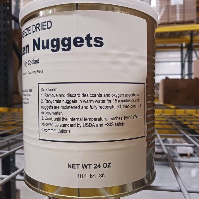 Close-up of a 24 oz can of freeze-dried chicken nuggets showing preparation instructions, displayed in a warehouse with metal shelving, featured in Kitchen & Food and Freeze Dried collections.