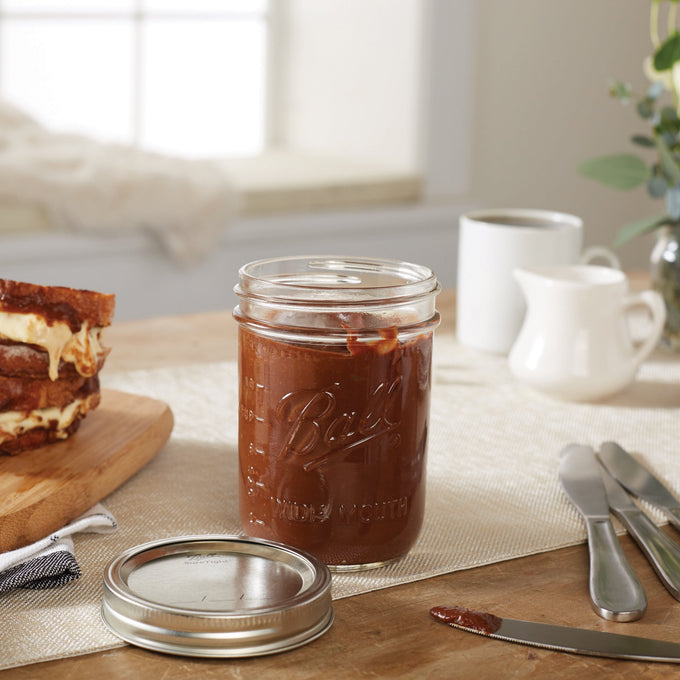Clear wide-mouth pint jar handcrafted in USA, filled with chocolate spread, shown with metal lid and knife, perfect for Kitchen & Food, Food Preservation, Canning, and Canning Jars and Accessories collections.