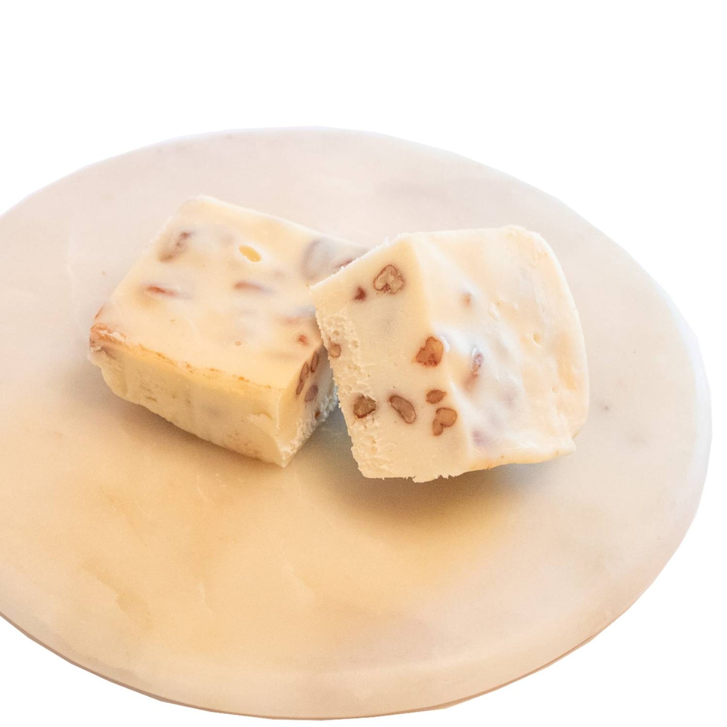Two handcrafted creamy white fudge squares with pecan pieces on a smooth light marble plate, featured in Kitchen & Food, Snacks and Sweets, USA Made, Best Sellers, and Promo Eligible collections.
