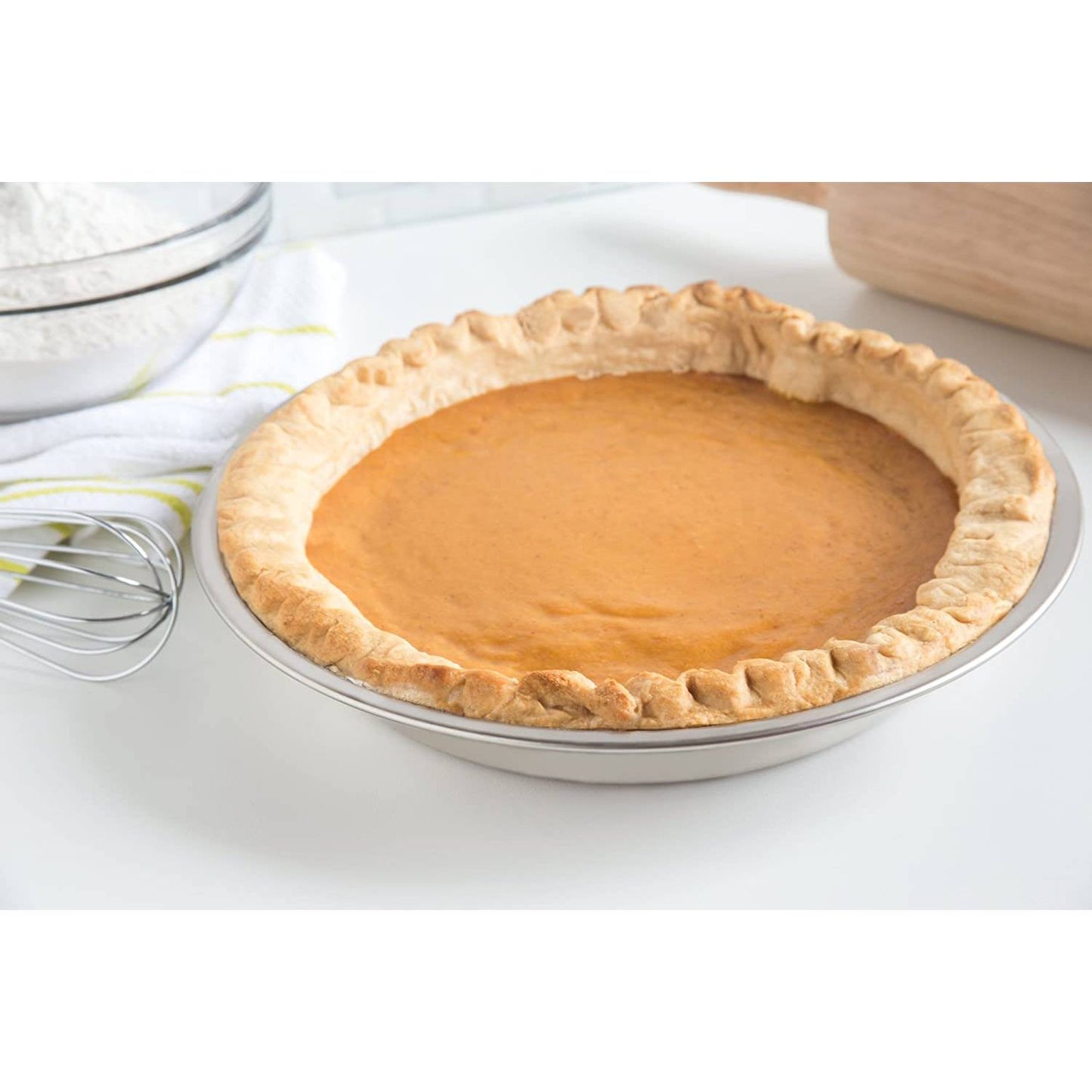 Golden baked pumpkin pie in a lightweight stainless steel 9-inch pie pan, showcased with baking tools on a kitchen counter, featured in Kitchen & Food and Baking Supplies collections.