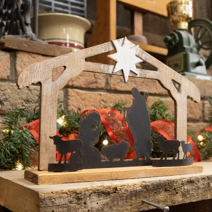 Handcrafted wooden nativity scene with weathered finish, featuring metal silhouettes of the Holy Family and animals under a star, ideal for Home & Decor, Holiday Decor, and Best Sellers collections.