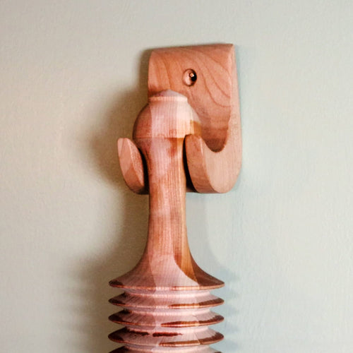 Handcrafted unfinished cherry wood wall-mounted holder with smooth curves and a mounting hole, designed for displaying Amish-made noodle cutter, fitting Kitchen & Food, Food Prep, Choppers and Cutters, and Amish Made collections.