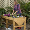 Woman gardening in a handcrafted wooden elevated garden bed designed for easy planting without bending, featured in Farm, Garden & Tool, Garden Accessories, Seeds and Planting, and Best Sellers collections.