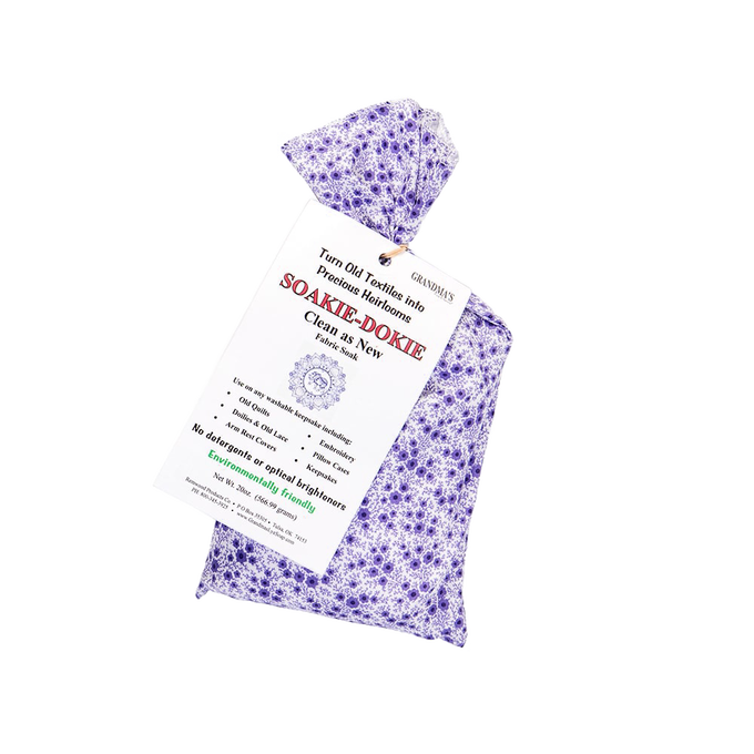 Lavender-patterned fabric sachet of Soakie-Dokie fabric soak with printed label highlighting gentle, detergent-free formula, made in USA, ideal for Home & Decor and Laundry Supplies collections.