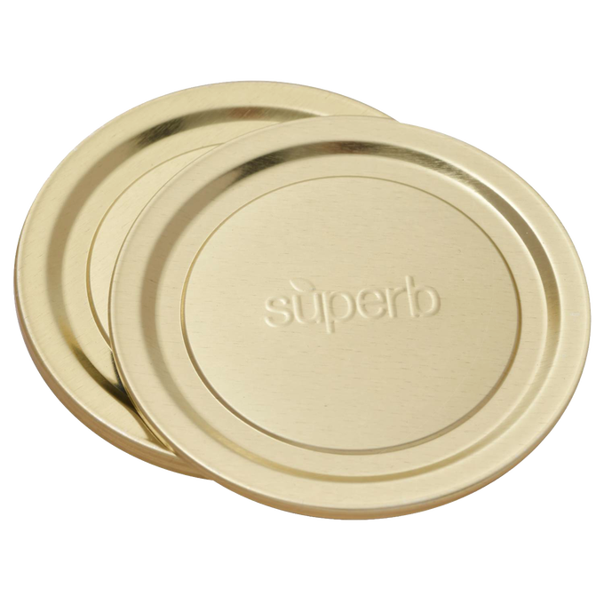 Pair of wide-mouth canning jar lids in a gold tone embossed with "superb," designed for secure food preservation, featured in Kitchen & Food, Canning, and USA Made collections.