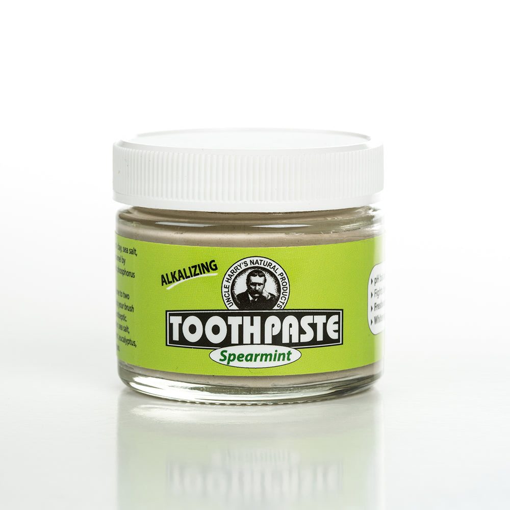 Handcrafted small glass jar of spearmint-flavored alkalizing toothpaste with a white lid and bright green label, featured in Health & Wellness, Grooming and Personal Hygiene, USA Made, and Best Sellers collections.