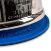 Blue temperature-resistant silicone coaster with raised branding, designed for camping and outdoor use to protect surfaces from hot lamps, featuring non-slip grip and hanging eyelet.